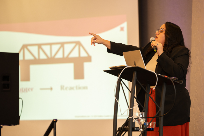 Miryam speaking from a lectern